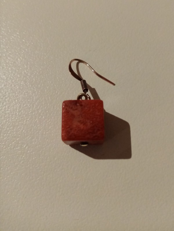 Boucle d'oreille de République Tchèque en forme de dé et de couleur orange au centre ville ou sur les quais allant vers la gare ou au ceili à Quimper