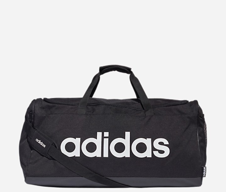 Sac Adidas noir perdu arrêt de bus longwy bas près d'un trottoir